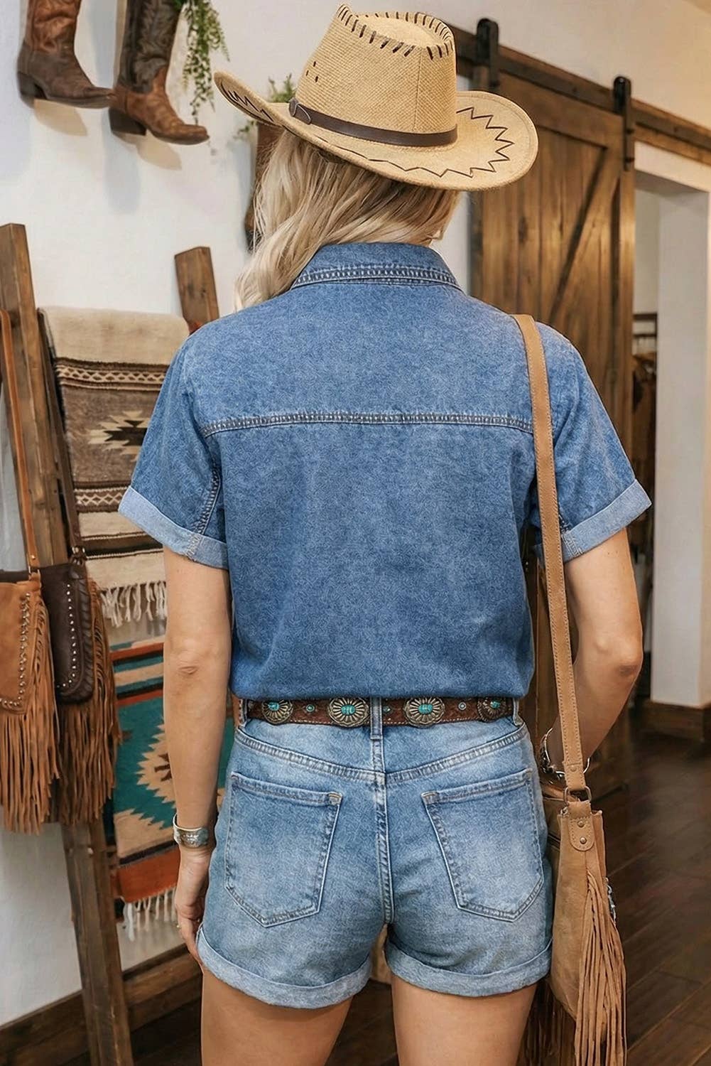 Blue denim button-up short sleeve shirt with back yoke seam and stitched hem