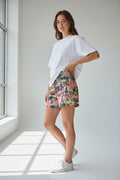 Multicolor printed shorts with abstract western motif, worn with a white T-shirt
