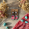 Turquoise serape oval drop earrings with colorful stripes and silver-tone border