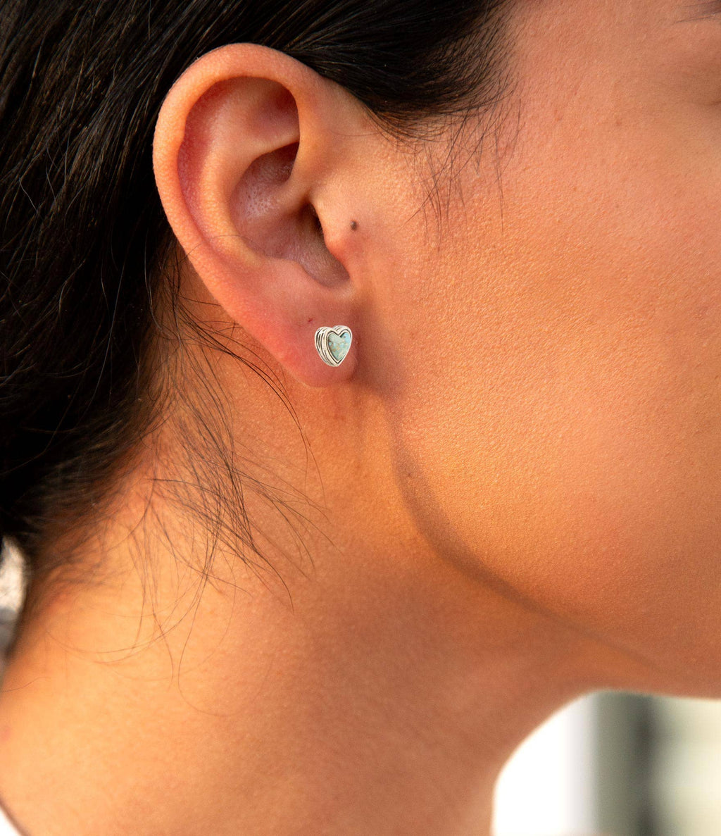 Heart turquoise stud earrings on ear, gold-tone heart setting