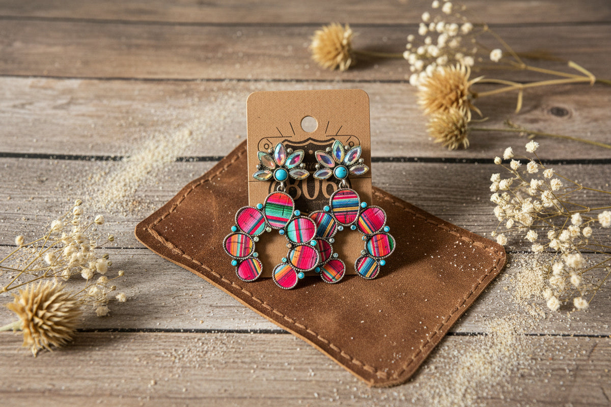 Colorful serape conch earrings with turquoise, pink, and red details