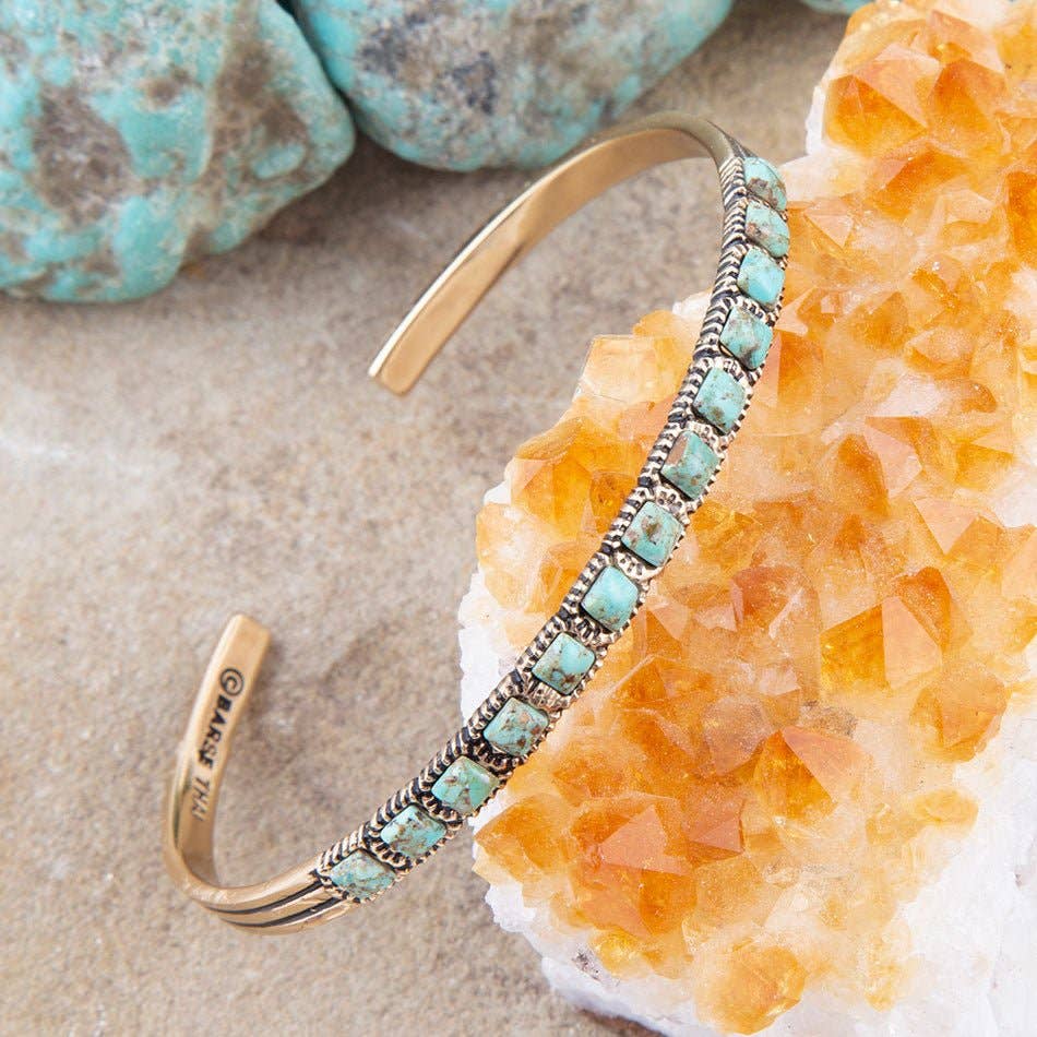 Close-up turquoise stone cuff bracelet with bronze bars and rope border detailing