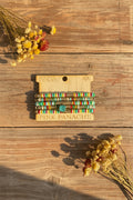 Stacked beaded bracelets with multicolor striped bands and round charm