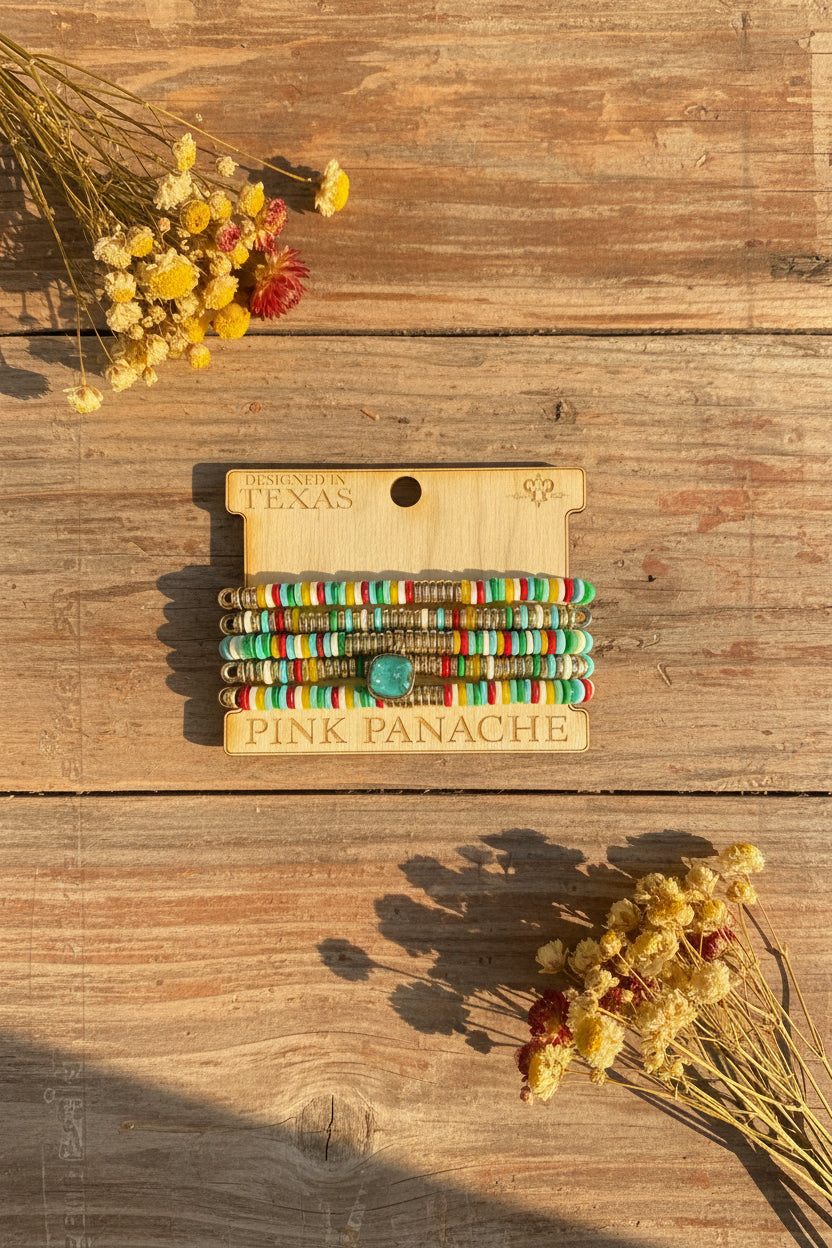 Stacked beaded bracelets with multicolor striped bands and round charm