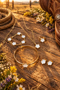 Gold-tone clover jewelry set: necklace, bracelet, ring, and four earrings