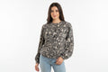 Women's crewneck sweater with ornate black-and-white swirl print, long sleeves
