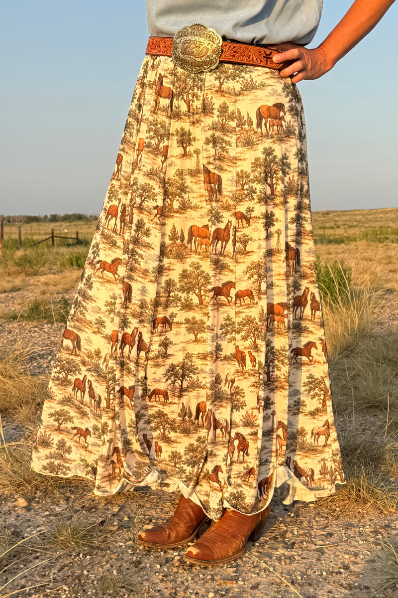 Tan maxi skirt with desert animal print and wide ornate belt at waist