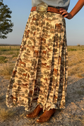 Tan maxi skirt with animal scene print and wide brown belt with gold buckle